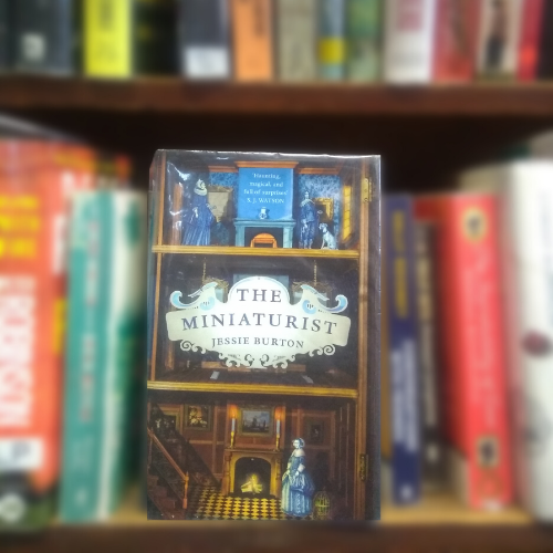 Shows based on books: front cover of the Miniaturist, showing illustrations of figures in grand interior.