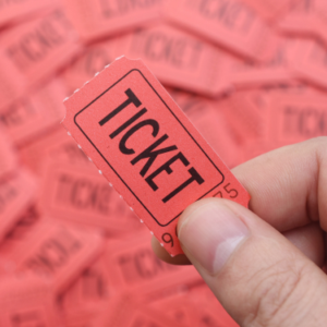 Hand holding a single red raffle ticket