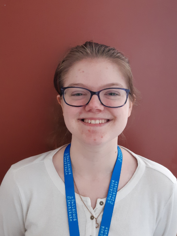 Volunteers' Week: Becca smiling, with brunette hair tied back and wearing a white top.